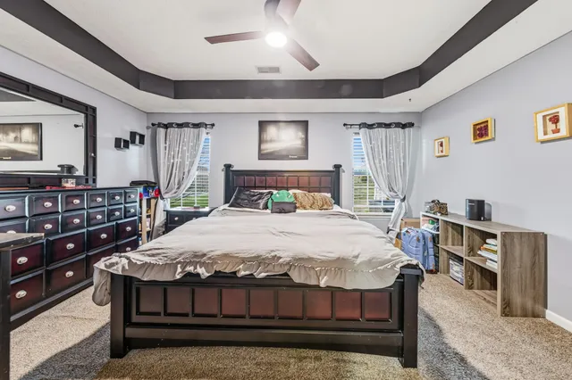 a bedroom with a bed next to a window