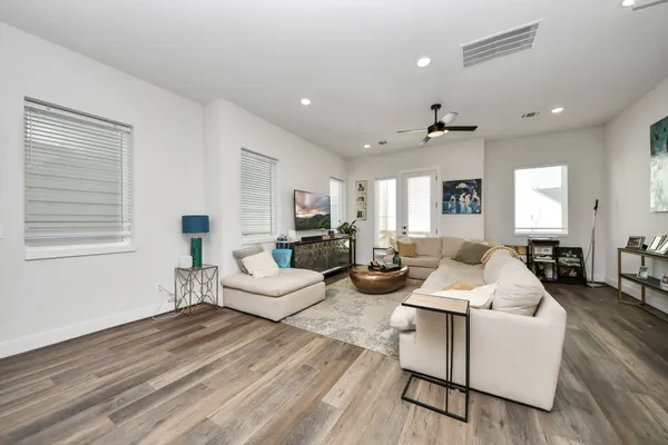 a living room with furniture and wooden floor