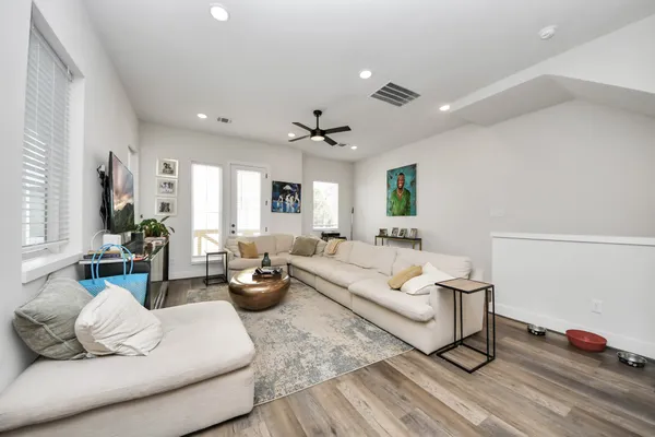 a living room with furniture or couch and a ceiling fan