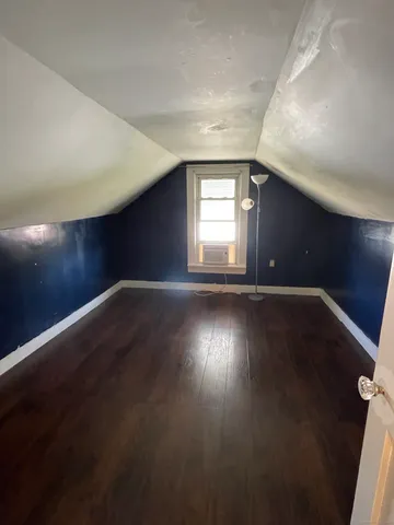 a view of wooden floor and windows in an empty room