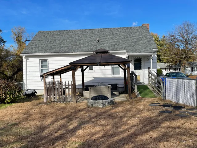 a backyard of a house with yard barbeque oven and outdoor seating