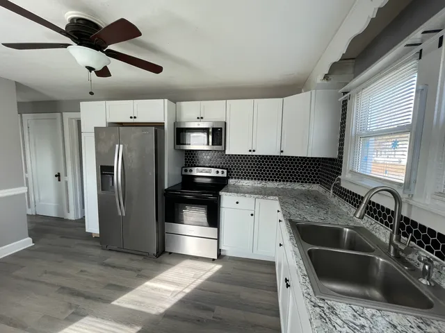 a kitchen with a sink stove and refrigerator