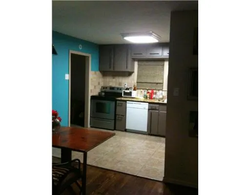 a kitchen with a sink cabinets and dining table