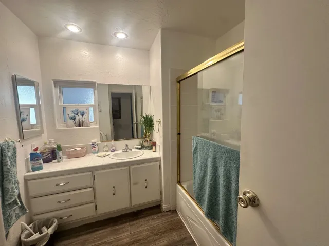 a bathroom with a double vanity sink a mirror and a shower