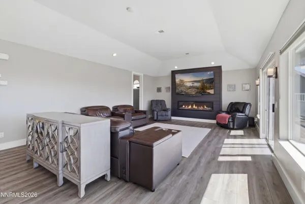 a kitchen with stainless steel appliances granite countertop a sink a stove a refrigerator and chairs