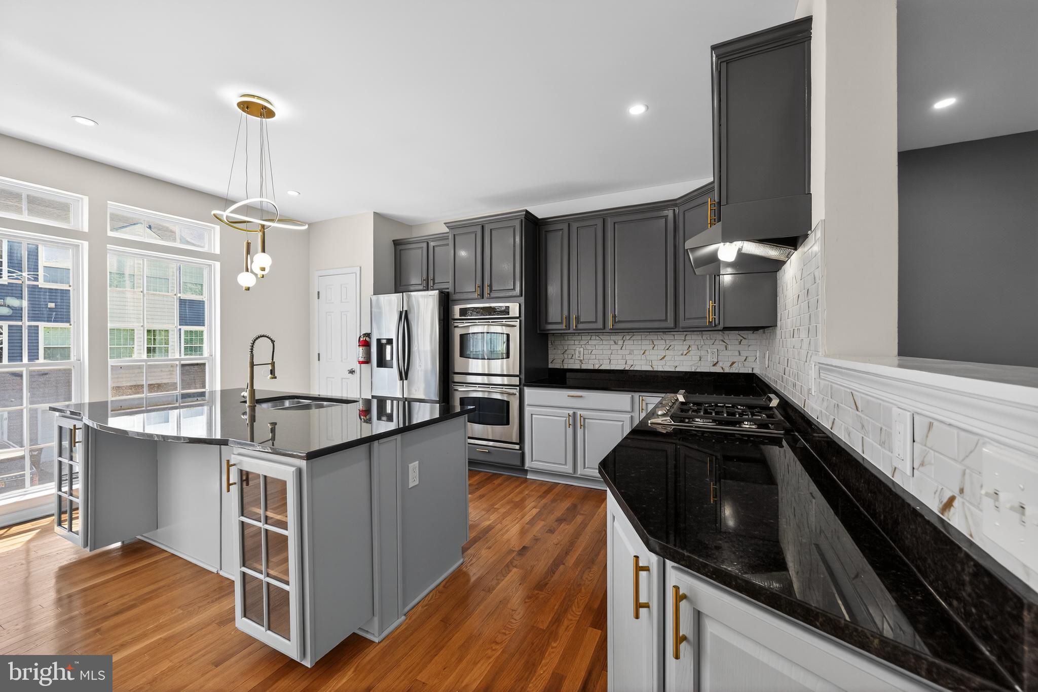 3 Swan Court Delran, NJ 08075 - Photo 12 of 34 a kitchen with a sink stove and cabinets