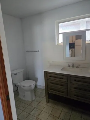 a bathroom with a sink toilet and mirror