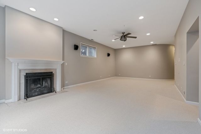 an empty room with a fireplace and fan
