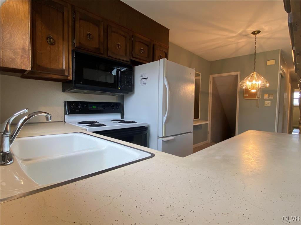 1516 Fairmount Street Bethlehem, PA 18017 - Photo 11 of 38 a kitchen with stainless steel appliances a refrigerator a sink a stove a microwave and cabinets