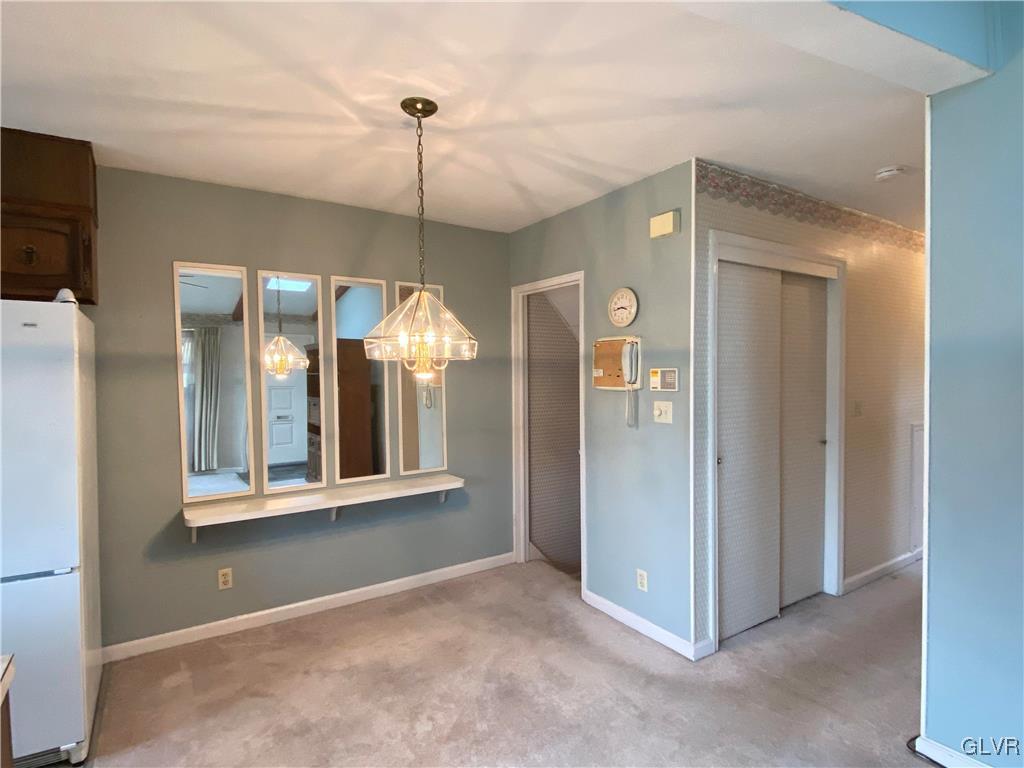 1516 Fairmount Street Bethlehem, PA 18017 - Photo 14 of 38 a view of a hallway with a chandelier fan and windows