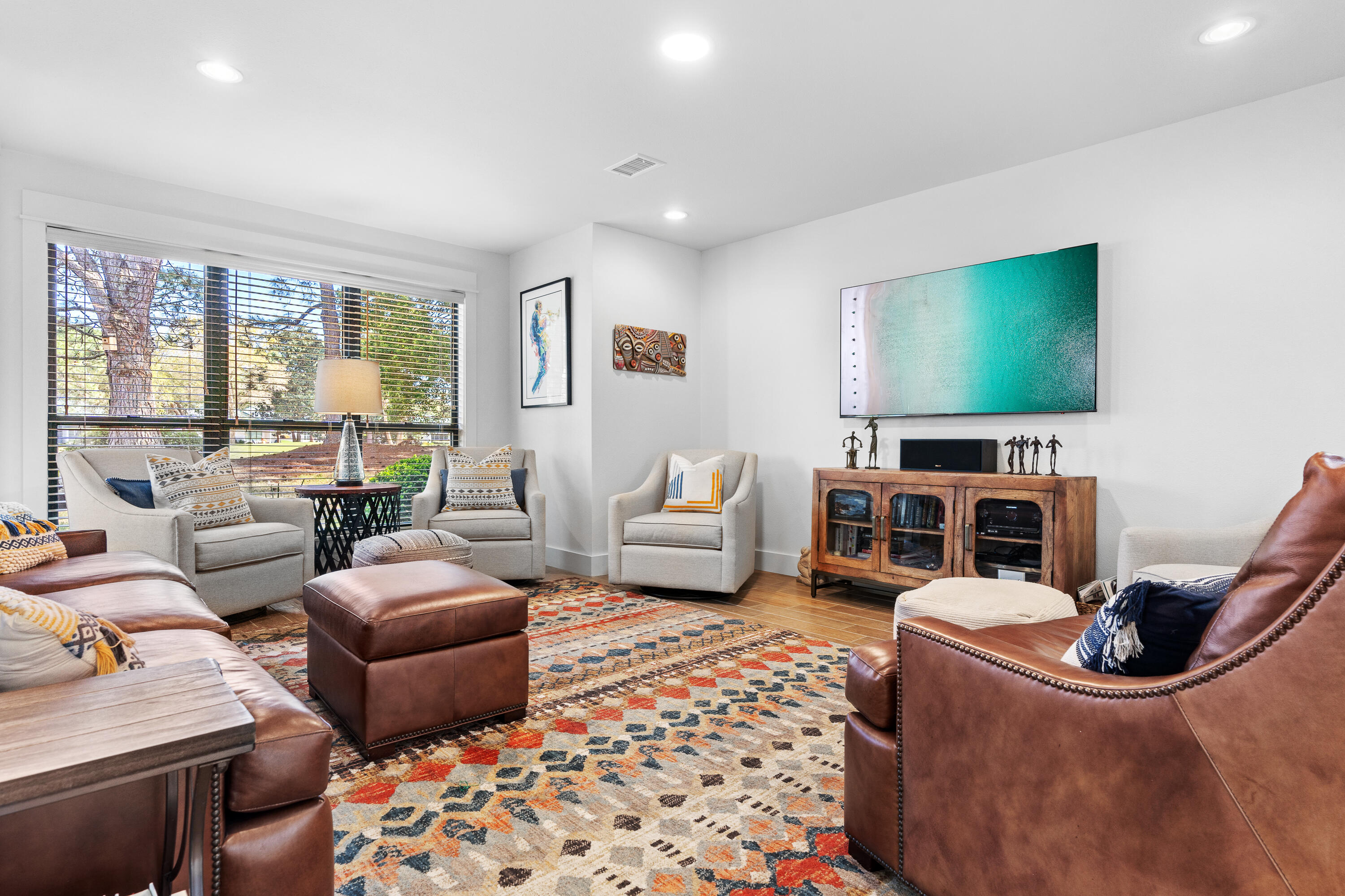 a living room with furniture a rug and a flat screen tv