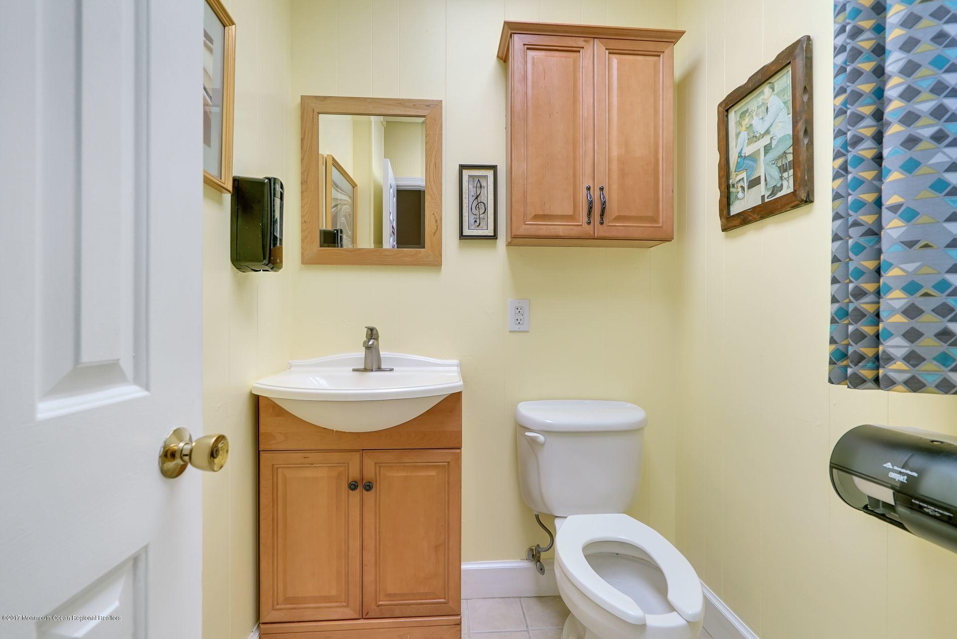 Union Avenue, Unit B Brielle, NJ 08730 - Photo 11 of 28 a bathroom with a toilet a sink and mirror