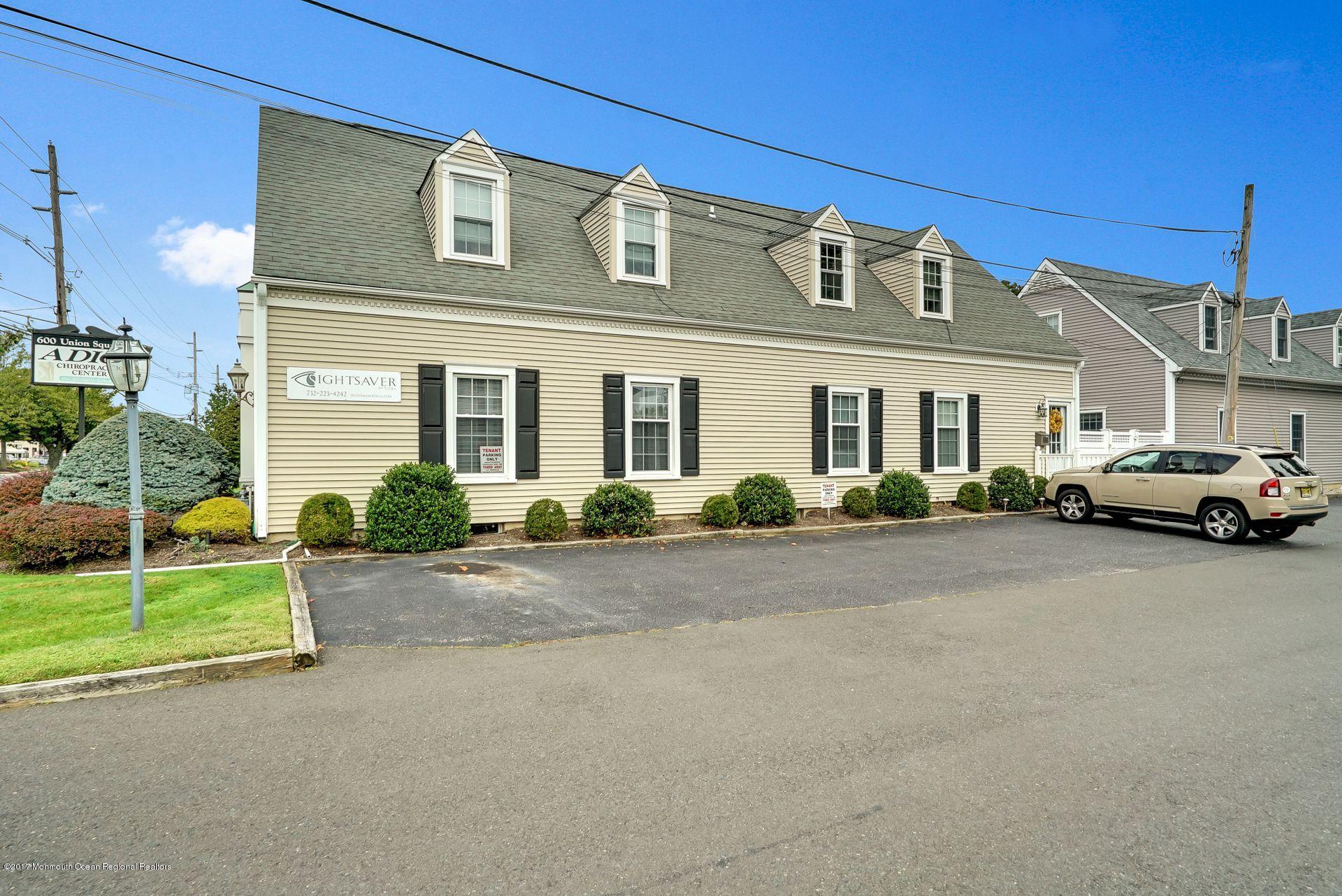 Union Avenue, Unit B Brielle, NJ 08730 - Photo 13 of 28 a front view of a house with a garden and car parked