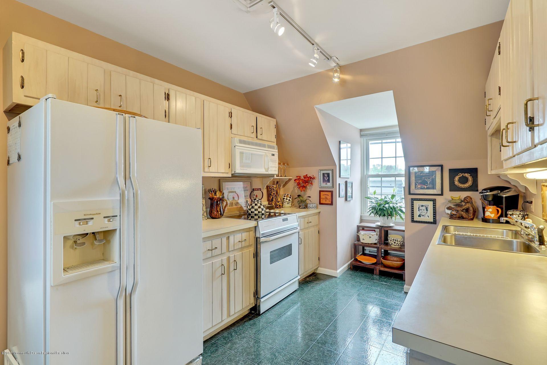 Union Avenue, Unit B Brielle, NJ 08730 - Photo 20 of 28 a kitchen with stainless steel appliances a refrigerator a sink a stove top oven a counter space and cabinets