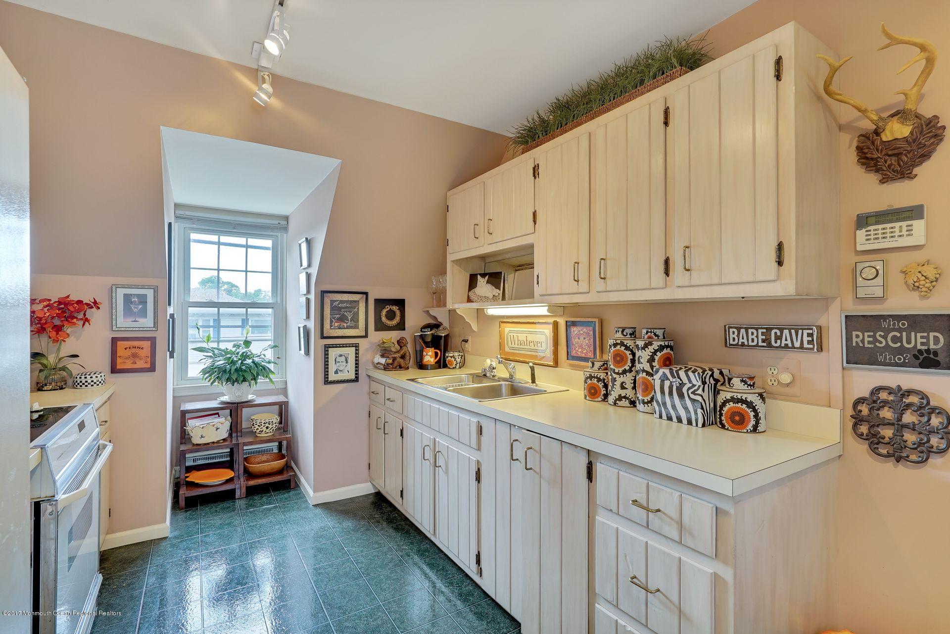 Union Avenue, Unit B Brielle, NJ 08730 - Photo 21 of 28 a kitchen with stainless steel appliances a white cabinets and a window