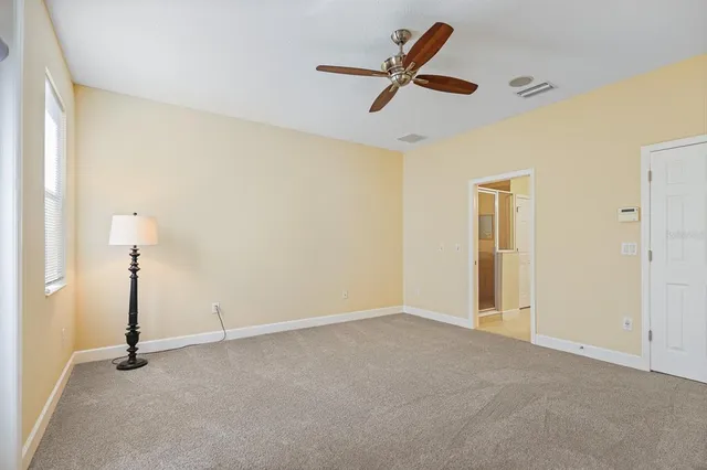 a view of a livingroom with a hardwood floor and a ceiling fan