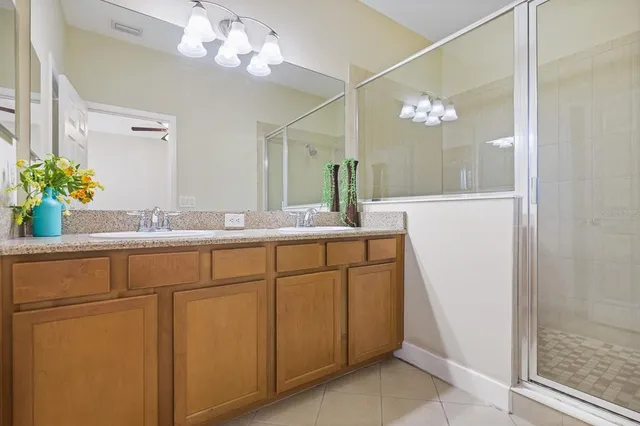 a bathroom with a sink mirror and vanity