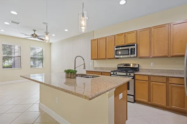 a kitchen with stainless steel appliances granite countertop a sink stove and microwave