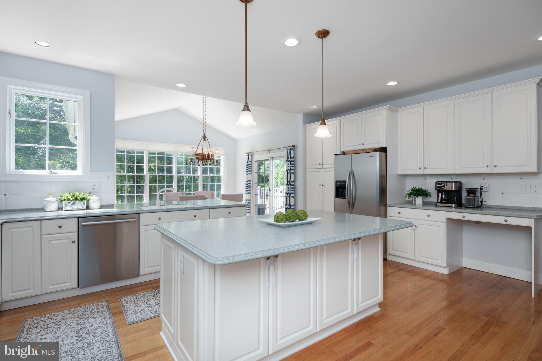 9 Deer Path Skillman, NJ 08558 - Photo 8 of 48 a kitchen with stainless steel appliances granite countertop a sink a stove a refrigerator and island with wooden floor
