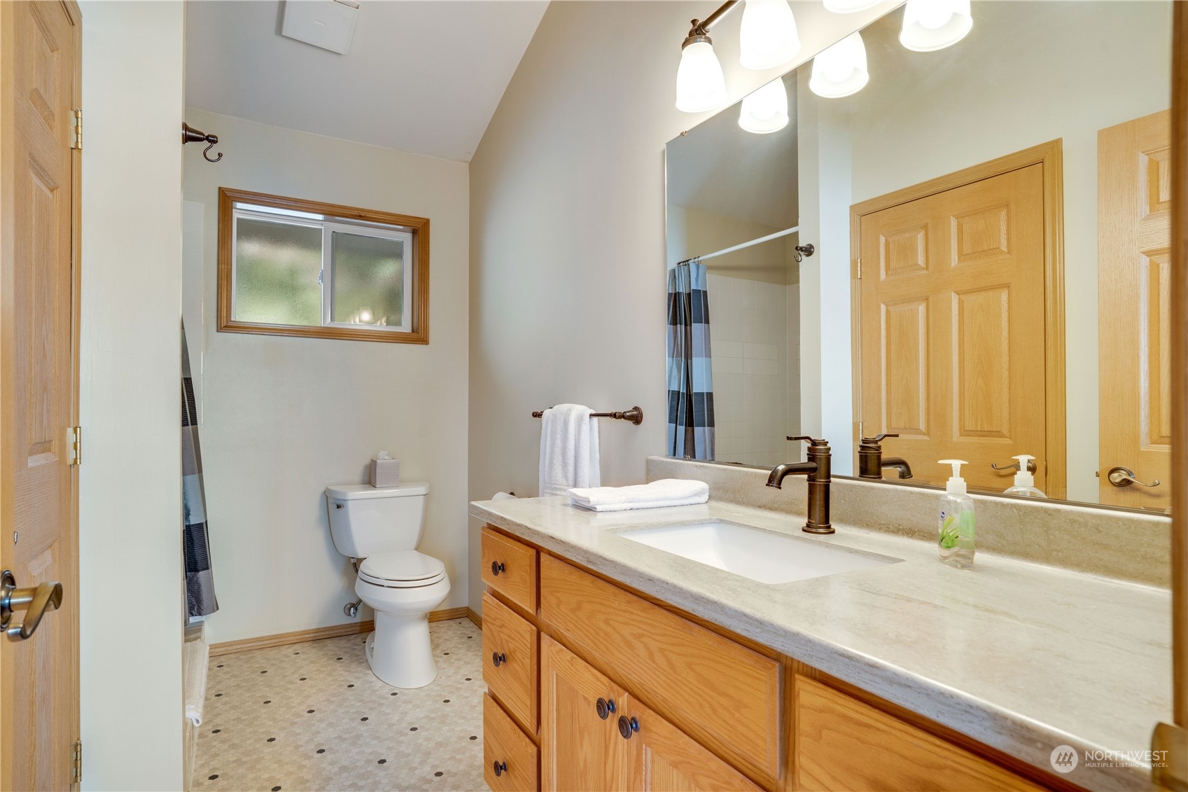 7381 Northeast North Shore Road Belfair, WA 98528 - Photo 24 of 38 a bathroom with a sink a toilet and a mirror