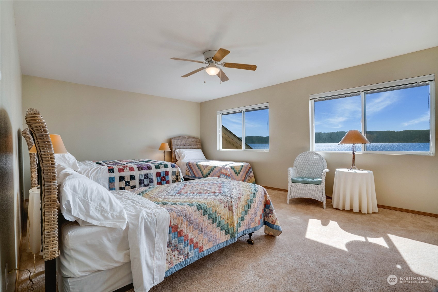 7381 Northeast North Shore Road Belfair, WA 98528 - Photo 29 of 38 a bedroom with two beds and a chandelier