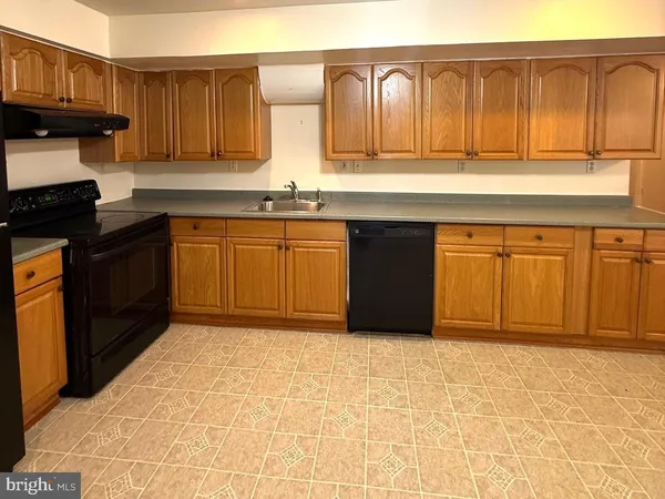 a kitchen with stainless steel appliances granite countertop a stove a sink and a granite counter tops