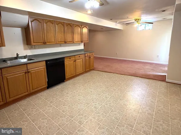 a kitchen with granite countertop a sink and cabinets