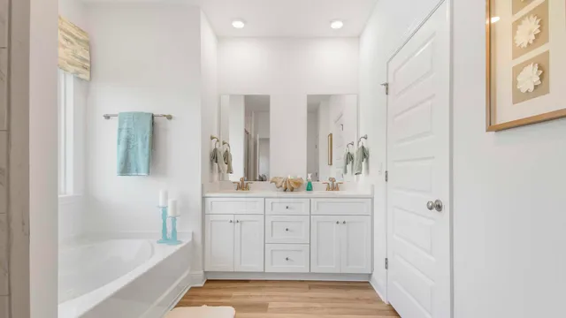 a bathroom with a tub sink shower and mirror