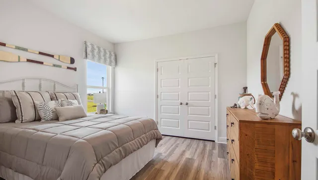 a bedroom with a bed and a mirror