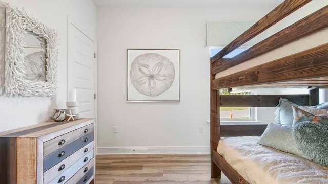 a bedroom with a bed and painting on the wall