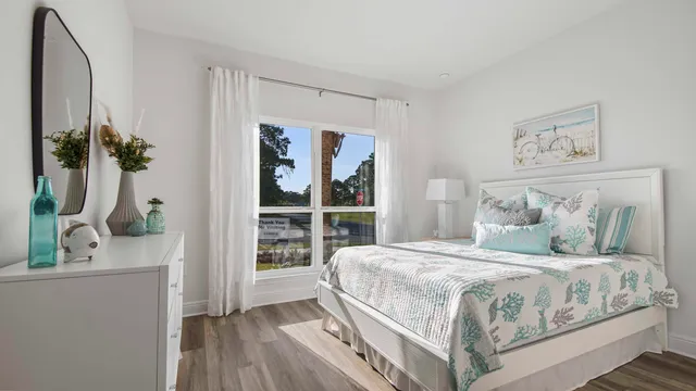 a bedroom with a large bed and a potted plant