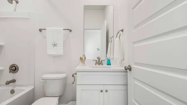 a bathroom with a sink toilet vanity and tub