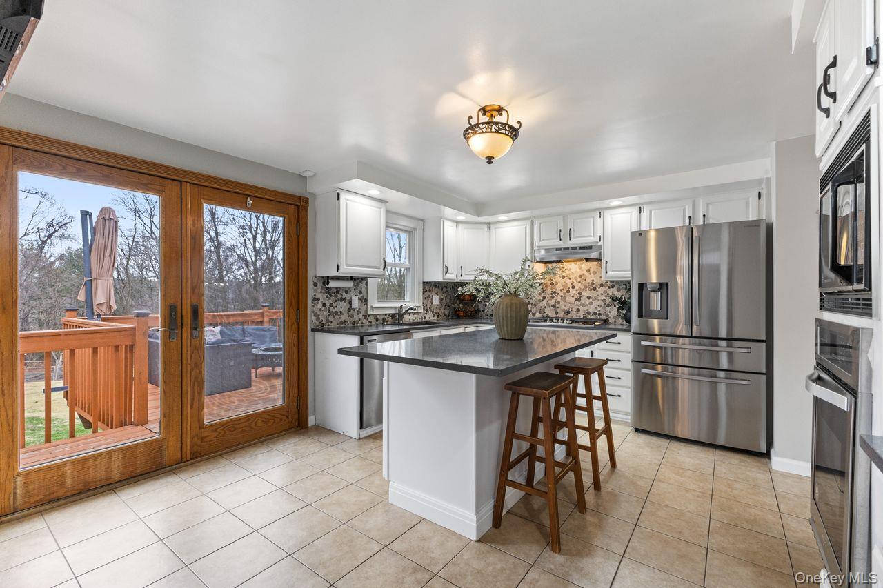 4 Stonewall Farm Road Mahopac, NY 10541 - Photo 11 of 37 French doors in kitchen leading to large deck overlooking yard.