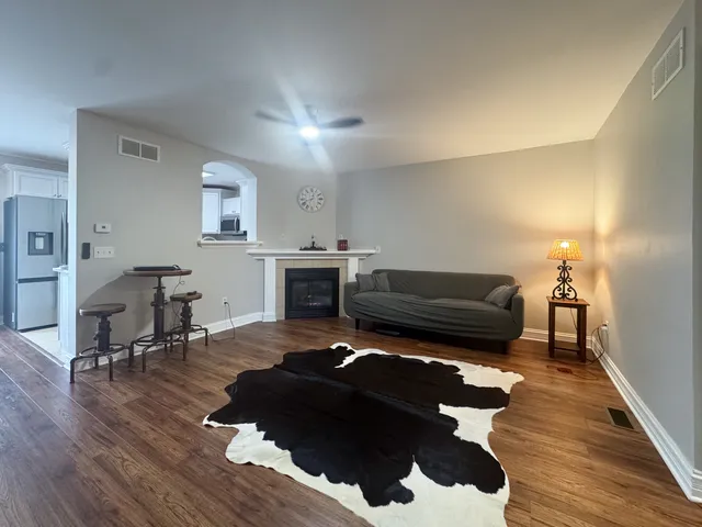 a living room with furniture and a fireplace