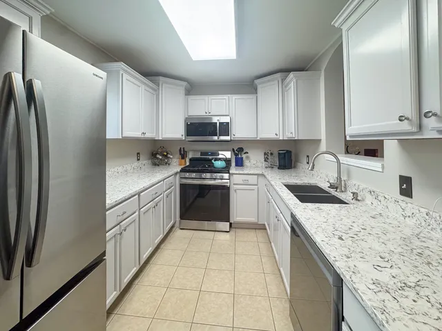 a kitchen with a stove top oven sink and cabinets