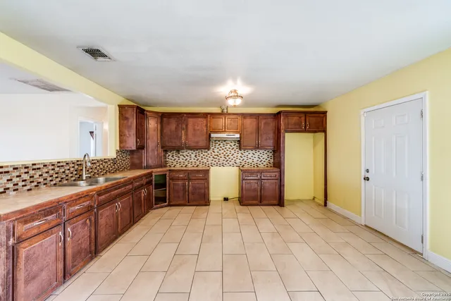 a kitchen with stainless steel appliances granite countertop a sink and cabinets