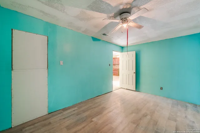 a view of a room with a fan and chandelier fan