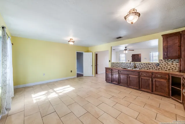 a large bathroom with a granite countertop double vanity sink a mirror and a bathtub