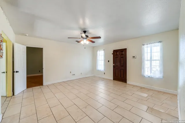 an empty room with windows and closet