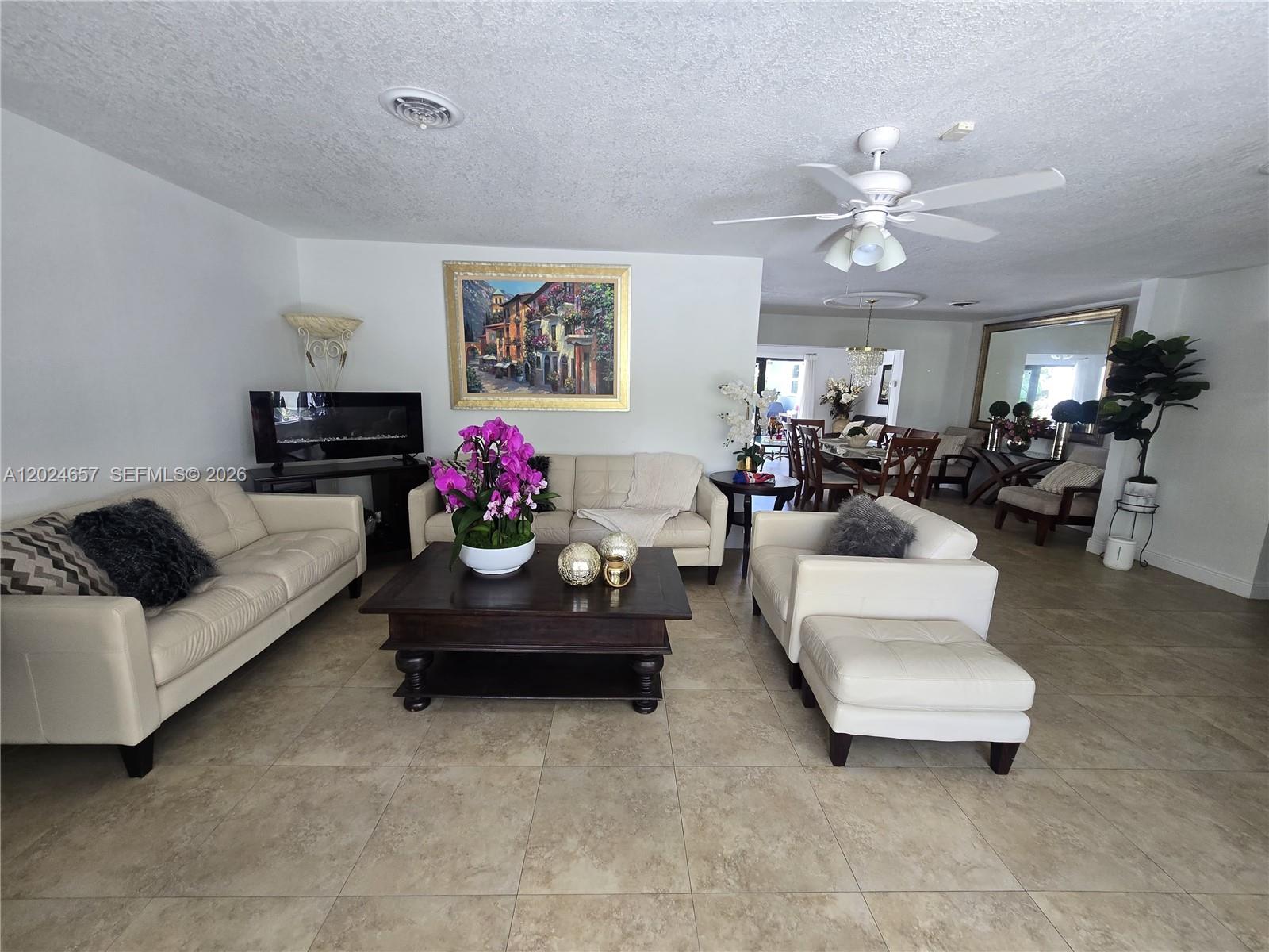 3619 West Park Road Hollywood, FL 33021 - Photo 4 of 19 a living room with furniture and a chandelier