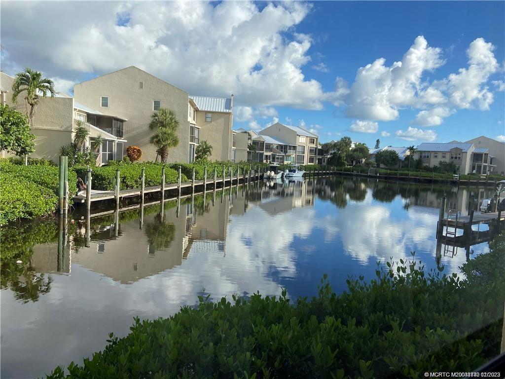 a view of a lake with a house in the background