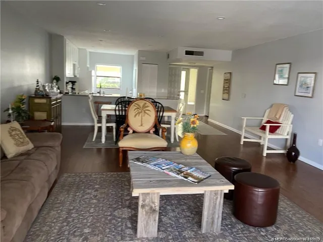 a living room with furniture a rug and a window
