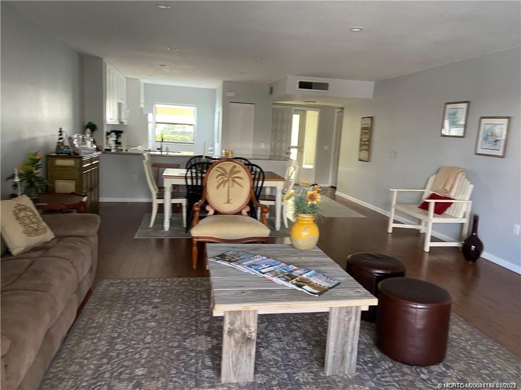 3901 Southeast St Lucie Boulevard, Unit D29 Stuart, FL 34997 - Photo 11 of 26 a living room with furniture a rug and a window