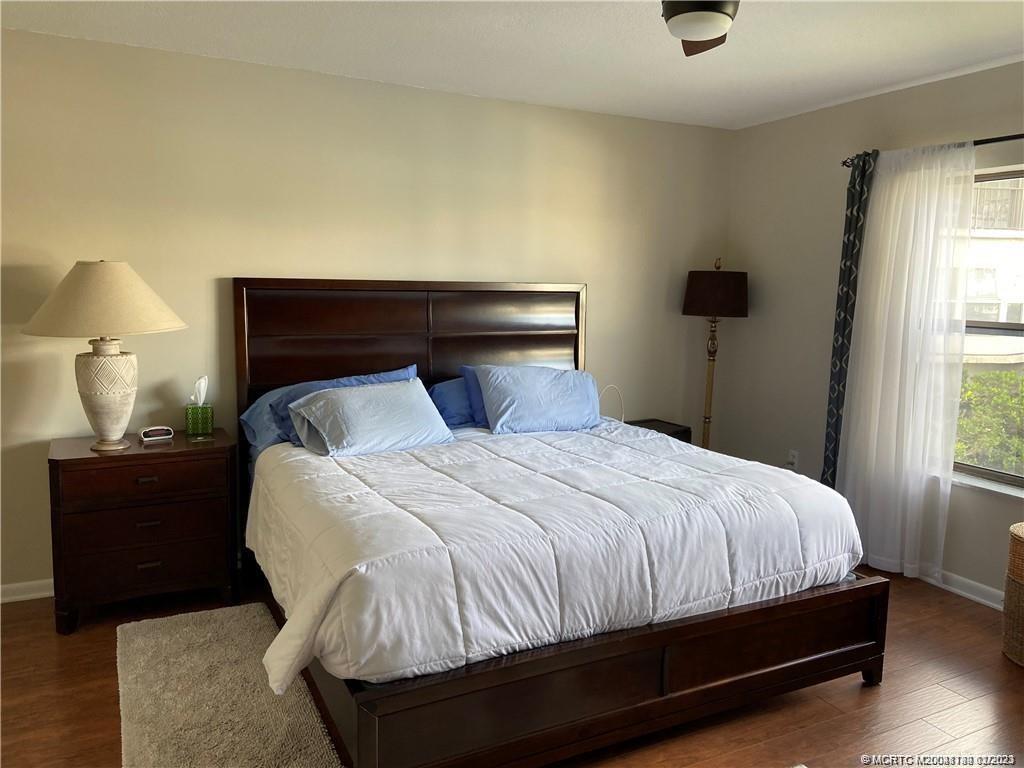 3901 Southeast St Lucie Boulevard, Unit D29 Stuart, FL 34997 - Photo 12 of 26 a bedroom with a bed and a lamp