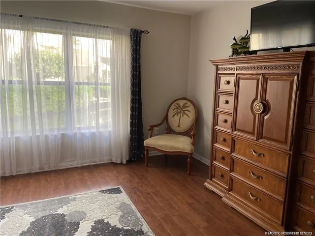 a view of room with window and wooden floor