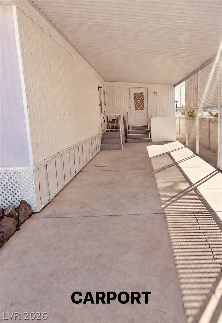 4556 Royal Ridge Way Las Vegas, NV 89103 - Photo 4 of 49 A spacious covered carport features concrete flooring and leads directly to the side entrances.