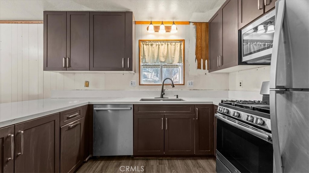 31347 Circle View Drive Running Springs, CA 92382 - Photo 13 of 48 a kitchen with a sink stove and cabinets