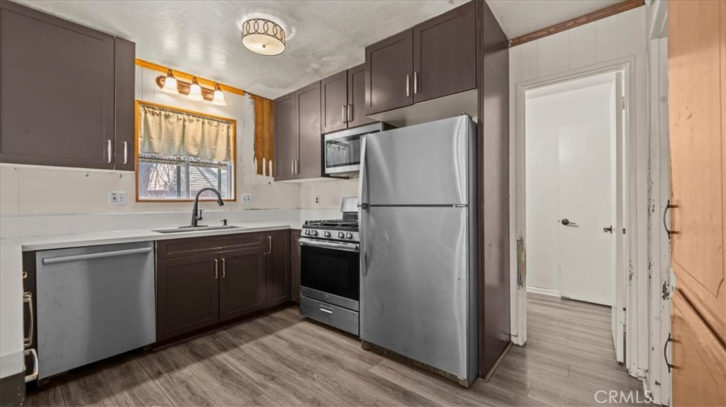 31347 Circle View Drive Running Springs, CA 92382 - Photo 14 of 48 a kitchen with stainless steel appliances granite countertop a refrigerator a sink a stove a washer and dryer