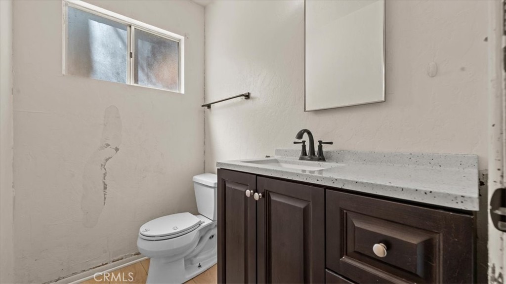 31347 Circle View Drive Running Springs, CA 92382 - Photo 21 of 48 a bathroom with a granite countertop toilet sink and mirror