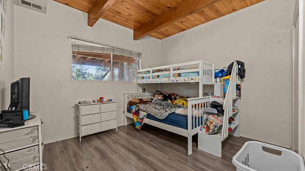 31347 Circle View Drive Running Springs, CA 92382 - Photo 22 of 48 a bed room with furniture and wooden floor